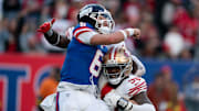 New York Giants quarterback Jaxson Dart takes a hit from the 49ers in last week's game.