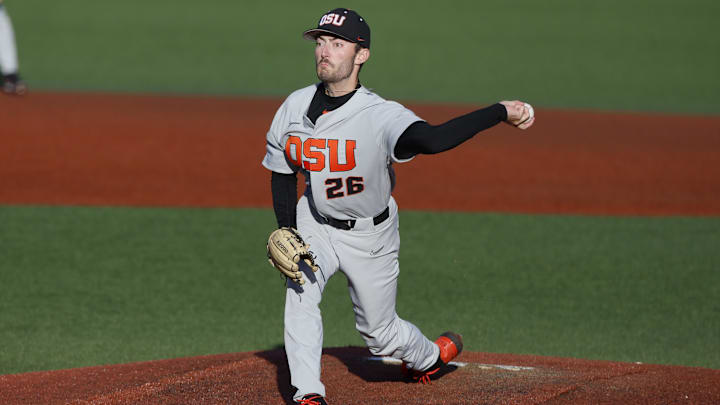 Jun 12, 2022; Corvallis, OR, USA; Oregon State Beavers pitcher Cooper Hjerpe (26) delivers a pitch in the 1st inning during Game 2 of a NCAA Super Regional game at Coleman Field. Mandatory Credit: Soobum Im-Imagn Images