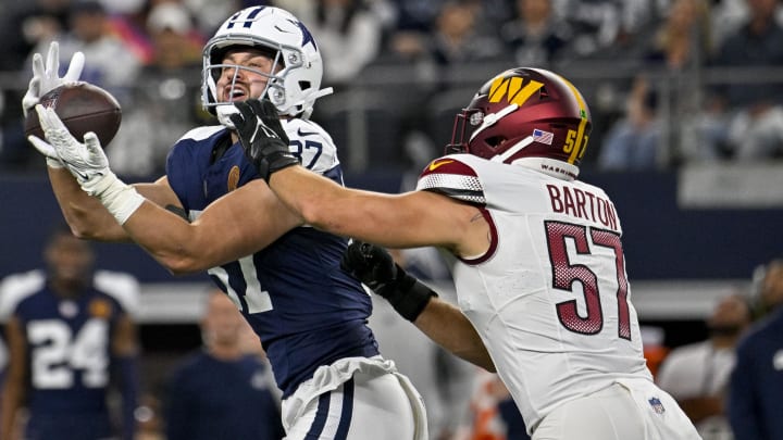 Nov 23, 2023; Arlington, Texas, USA; Dallas Cowboys tight end Jake Ferguson (87) catches a pass for a first down over Washington Commanders linebacker Cody Barton (57) during the first quarter at AT&T Stadium. Mandatory Credit: Jerome Miron-USA TODAY Sports