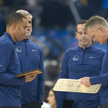 Dec 5, 2022; San Francisco, California, USA; Golden State Warriors head coach Steve Kerr (right) consults with his staff during a timeout in the first quarter against the Indiana Pacers at Chase Center. Mandatory Credit: D. Ross Cameron-USA TODAY Sports