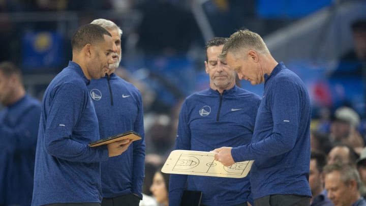 Dec 5, 2022; San Francisco, California, USA; Golden State Warriors head coach Steve Kerr (right) consults with his staff during a timeout in the first quarter against the Indiana Pacers at Chase Center. Mandatory Credit: D. Ross Cameron-USA TODAY Sports