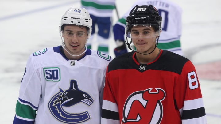 Oct 19, 2019; Newark, NJ, USA; Vancouver Canucks defenseman Quinn Hughes (43) and New Jersey Devils center Jack Hughes (86) pose for a photo during warmups for their NHL game at Prudential Center. Mandatory Credit: Ed Mulholland-USA TODAY Sports