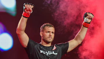Logan Storley raises his arms as he enters his fight with Luca Poclit on Friday, June 28, 2024, at Sanford Pentagon in Sioux Falls.