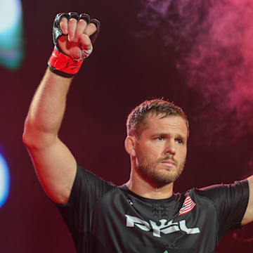 Logan Storley raises his arms as he enters his fight with Luca Poclit on Friday, June 28, 2024, at Sanford Pentagon in Sioux Falls.