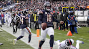 Nov 9, 2025; Chicago, Illinois, USA; Chicago Bears quarterback Caleb Williams (18) scores the game-winning touchdown against New York Giants linebacker Brian Burns (0) during the fourth quarter at Soldier Field. Mandatory Credit: David Banks-Imagn Images