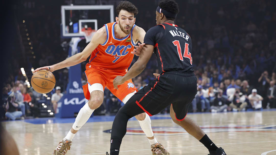 Jan 25, 2026; Oklahoma City, Oklahoma, USA;  Oklahoma City Thunder center/forward Chet Holmgren (7) moves the ball down the court as Toronto Raptors guard Ja'kobe Walter (14) defends during the first quarter at Paycom Center. Mandatory Credit: Alonzo Adams-Imagn Images