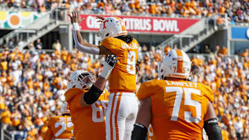 Jan 1, 2024; Orlando, FL, USA; Tennessee Volunteers quarterback Nico Iamaleava (8) and offensive lineman Masai Reddick (68) celebrate a touchdown against the Iowa Hawkeyes during the second quarter at Camping World Stadium. Mandatory Credit: Morgan Tencza-USA TODAY Sports
