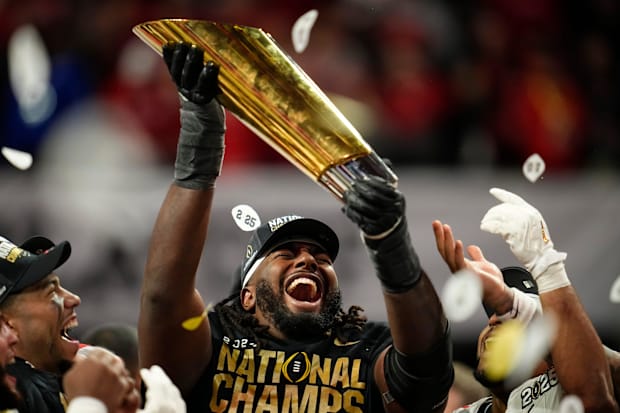 Ohio State Buckeyes wide receiver Jeremiah Smith (4) holds the trophy following the 34-23 win over Notre Dame.