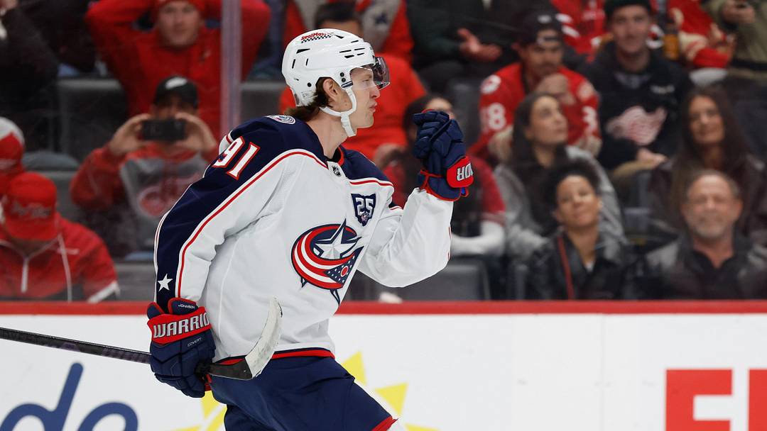 Apr 7, 2026; Detroit, Michigan, USA;  Columbus Blue Jackets center Kent Johnson (91) celebrates after scoring in a shootout against the Detroit Red Wings at Little Caesars Arena. Mandatory Credit: Rick Osentoski-Imagn Images