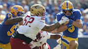 Oct 4, 2025; Pittsburgh, Pennsylvania, USA; Pittsburgh Panthers quarterback Mason Heintschel (6) runs the ball against Boston College Eagles defensive lineman Chris Marable Jr. (52) during the first quarter at Acrisure Stadium. Mandatory Credit: Charles LeClaire-Imagn Images