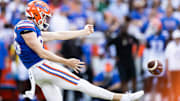Aug 31, 2024; Gainesville, Florida, USA; Florida Gators punter Jeremy Crawshaw (26) punts the ball against the Miami Hurricanes during the first half at Ben Hill Griffin Stadium. Mandatory Credit: Matt Pendleton-Imagn Images