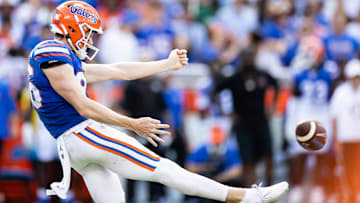 Aug 31, 2024; Gainesville, Florida, USA; Florida Gators punter Jeremy Crawshaw (26) punts the ball against the Miami Hurricanes during the first half at Ben Hill Griffin Stadium. Mandatory Credit: Matt Pendleton-Imagn Images