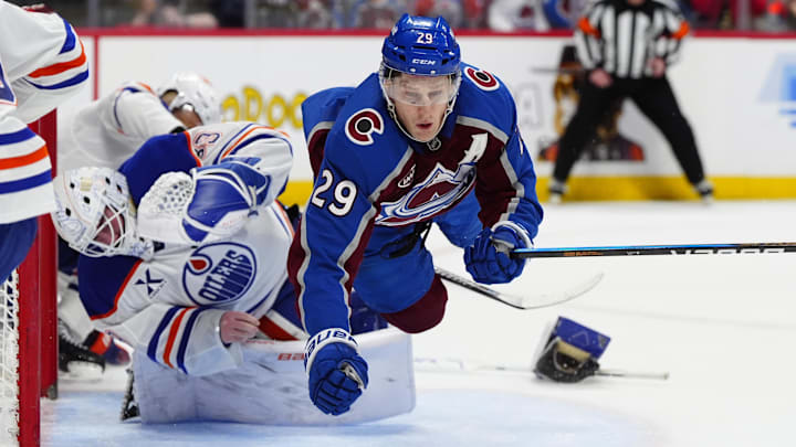 Mar 10, 2026; Denver, Colorado, USA; Colorado Avalanche center Nathan MacKinnon (29) collides into Edmonton Oilers goaltender Connor Ingram (39) in the second period at Ball Arena. Mandatory Credit: Ron Chenoy-Imagn Images