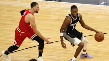 Feb 20, 2021; Chicago, Illinois, USA; Sacramento Kings guard De'Aaron Fox (5) dribbles the ball against Chicago Bulls guard Zach LaVine (8) during the second half at the United Center. Mandatory Credit: Mike Dinovo-Imagn Images