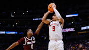 Mar 20, 2025; Denver, CO, USA; Wisconsin Badgers guard John Tonje (9) shoots the ball against Montana Grizzlies guard Money Williams (0) during the first half in the first round of the NCAA Tournament at Ball Arena. Mandatory Credit: Isaiah J. Downing-Imagn Images