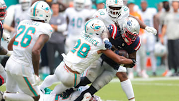 Sep 14, 2025; Miami Gardens, Florida, USA; New England Patriots running back Rhamondre Stevenson (38) carries the football against Miami Dolphins safety Minkah Fitzpatrick (29) during the fourth quarter at Hard Rock Stadium. Mandatory Credit: Sam Navarro-Imagn Images