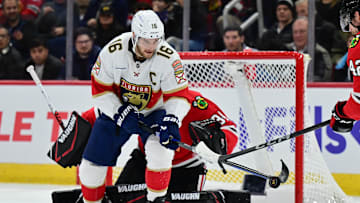 Nov 21, 2024; Chicago, Illinois, USA; Florida Panthers center Aleksander Barkov (16) plays the puck as Chicago Blackhawks goaltender Petr Mrazek (34) defends his goal during the first period at the United Center. Mandatory Credit: Daniel Bartel-Imagn Images