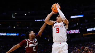 Mar 20, 2025; Denver, CO, USA; Wisconsin Badgers guard John Tonje (9) shoots the ball against Montana Grizzlies guard Money Williams (0) during the first half in the first round of the NCAA Tournament at Ball Arena. Mandatory Credit: Isaiah J. Downing-Imagn Images
