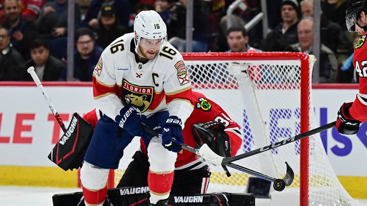 Nov 21, 2024; Chicago, Illinois, USA; Florida Panthers center Aleksander Barkov (16) plays the puck as Chicago Blackhawks goaltender Petr Mrazek (34) defends his goal during the first period at the United Center. Mandatory Credit: Daniel Bartel-Imagn Images
