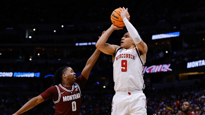 Mar 20, 2025; Denver, CO, USA; Wisconsin Badgers guard John Tonje (9) shoots the ball against Montana Grizzlies guard Money Williams (0) during the first half in the first round of the NCAA Tournament at Ball Arena. Mandatory Credit: Isaiah J. Downing-Imagn Images