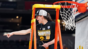 Mar 6, 2022; Indianapolis, IN, USA;  Iowa Hawkeyes guard Caitlin Clark (22) celebrates after cutting a piece of the net after defeating Indiana in the Big Ten conference tournament championship game between Iowa and Indiana at Gainbridge Fieldhouse. Mandatory Credit: Robert Goddin-Imagn Images