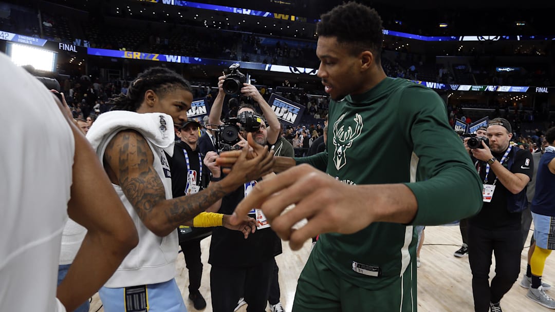 Dec 15, 2022; Memphis, Tennessee, USA; Memphis Grizzlies guard Ja Morant (left) and Milwaukee Bucks forward Giannis Antetokounmpo (34) shake hands after the game at FedExForum. Mandatory Credit: Petre Thomas-Imagn Images