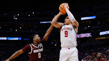 Mar 20, 2025; Denver, CO, USA; Wisconsin Badgers guard John Tonje (9) shoots the ball against Montana Grizzlies guard Money Williams (0) during the first half in the first round of the NCAA Tournament at Ball Arena. Mandatory Credit: Isaiah J. Downing-Imagn Images