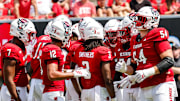 Sep 6, 2025; Raleigh, North Carolina, USA; North Carolina State Wolfpack huddle during the first half of the game against Virginia Cavaliers at Carter-Finley Stadium. Mandatory Credit: Jaylynn Nash-Imagn Images