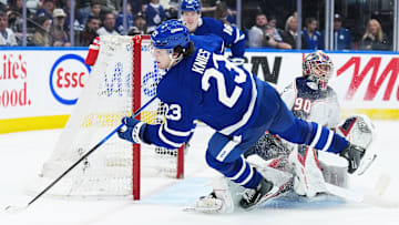 Apr 5, 2025; Toronto, Ontario, CAN; Toronto Maple Leafs left wing Matthew Knies (23) battles for the puck with Columbus Blue Jackets goaltender Elvis Merzlikins (90) during the third period at Scotiabank Arena. Mandatory Credit: Nick Turchiaro-Imagn Images