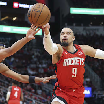 Dec 11, 2023; Houston, Texas, USA; San Antonio Spurs forward Keldon Johnson (3) and Houston Rockets forward Dillon Brooks (9) attempt to get control of the ball during the third quarter at Toyota Center. Mandatory Credit: Troy Taormina-Imagn Images