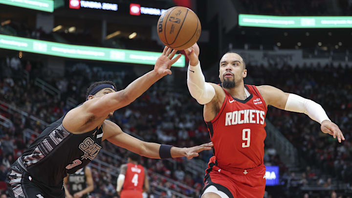 Dec 11, 2023; Houston, Texas, USA; San Antonio Spurs forward Keldon Johnson (3) and Houston Rockets forward Dillon Brooks (9) attempt to get control of the ball during the third quarter at Toyota Center. Mandatory Credit: Troy Taormina-Imagn Images