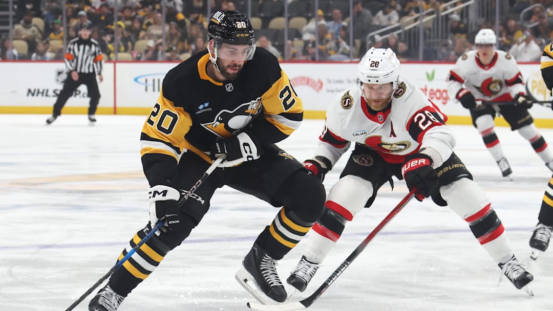 Mar 30, 2025; Pittsburgh, Pennsylvania, USA;  Pittsburgh Penguins defenseman Conor Timmins (20) moves the puck against Ottawa Senators right wing Claude Giroux (28) during the first period at PPG Paints Arena. Mandatory Credit: Charles LeClaire-Imagn Images