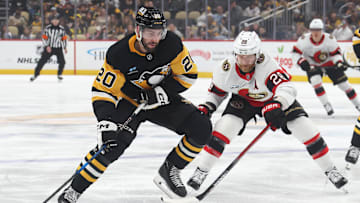 Mar 30, 2025; Pittsburgh, Pennsylvania, USA;  Pittsburgh Penguins defenseman Conor Timmins (20) moves the puck against Ottawa Senators right wing Claude Giroux (28) during the first period at PPG Paints Arena. Mandatory Credit: Charles LeClaire-Imagn Images