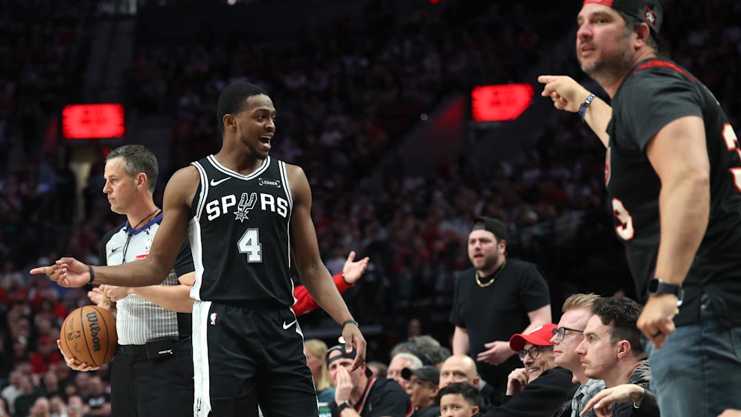 Apr 24, 2026; Portland, Oregon, USA; San Antonio Spurs guard De'Aaron Fox (4) banters with the Portland Trail Blazers’ fans after a play during the second half during Game 3 of the first round of the 2026 NBA Playoffs at Moda Center.