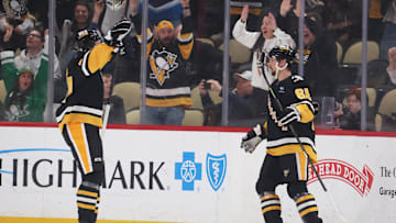 Mar 11, 2025; Pittsburgh, Pennsylvania, USA;  Pittsburgh Penguins right wing Rickard Rakell (left) and defenseman Erik Karlsson (65) celebrate the game winning goal by Karlsson to defeat the Vegas Golden Knights in overtime at PPG Paints Arena. Mandatory Credit: Charles LeClaire-Imagn Images
