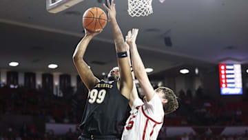 Feb 1, 2025; Norman, Oklahoma, USA; Vanderbilt Commodores forward Devin McGlockton (99) shoots the ball against Oklahoma Sooners forward Luke Northweather (45) during the first half at Lloyd Noble Center. Mandatory Credit: Alonzo Adams-Imagn Images