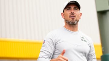 Green Bay Packers head coach Matt LaFleur walks to the field during training camp at Ray Nitschke Field.