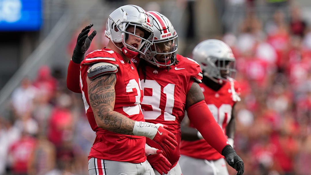 Aug 31, 2024; Columbus, OH, USA; Ohio State Buckeyes defensive end Jack Sawyer (33) gets a hug from defensive tackle Tyleik Williams (91) during the first half of the NCAA football game against the Akron Zips at Ohio Stadium.