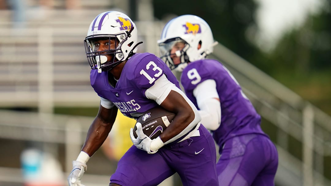 St. Francis DeSales running back Jonathan Brown (13) takes a handoff from quarterback RJ Day (9) during Week 1 of high school football at DeSales High School on Aug. 22, 2025.