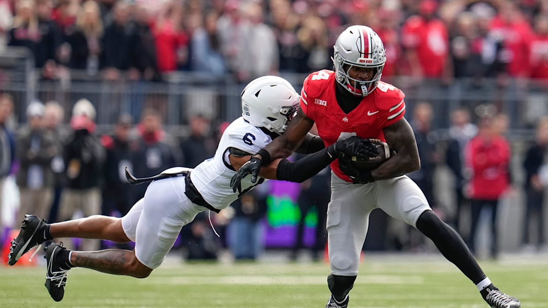 Ohio State Buckeyes wide receiver Jeremiah Smith (4) catches a pass in front of Penn State Nittany Lions safety Zakee Wheatley (6) during the NCAA football game at Ohio Stadium in Columbus on Nov. 1, 2025.