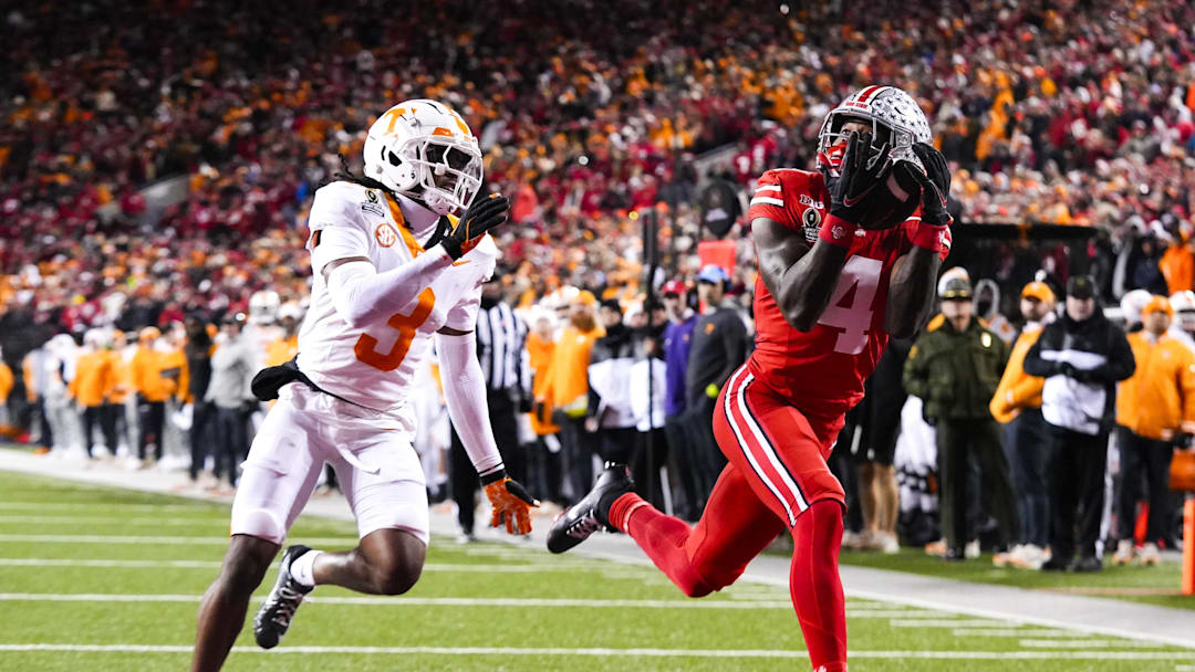 Dec 21, 2024; Columbus, Ohio, USA; Ohio State Buckeyes wide receiver Jeremiah Smith (4) catches a touchdown pass against Tennessee Volunteers defensive back Jermod McCoy (3) in the second half at Ohio Stadium. Mandatory Credit: Samantha Madar/USA Today Network via Imagn Images Dec 21, 2024; Columbus, Ohio, USA; Ohio State Buckeyes wide receiver Jeremiah Smith (4) catches a touchdown pass against Tennessee Volunteers defensive back Jermod McCoy (3) in the second half at Ohio Stadium. Mandatory Credit: Samantha Madar/USA Today Network via Imagn Images