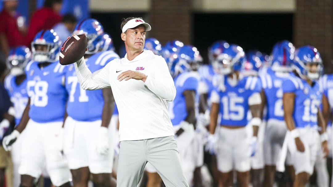 Nov 15, 2025; Oxford, Mississippi, USA; Mississippi Rebels head coach Lane Kiffin throws a football during pregame warmups against the Florida Gators at Vaught-Hemingway Stadium. Mandatory Credit: Petre Thomas-Imagn Images