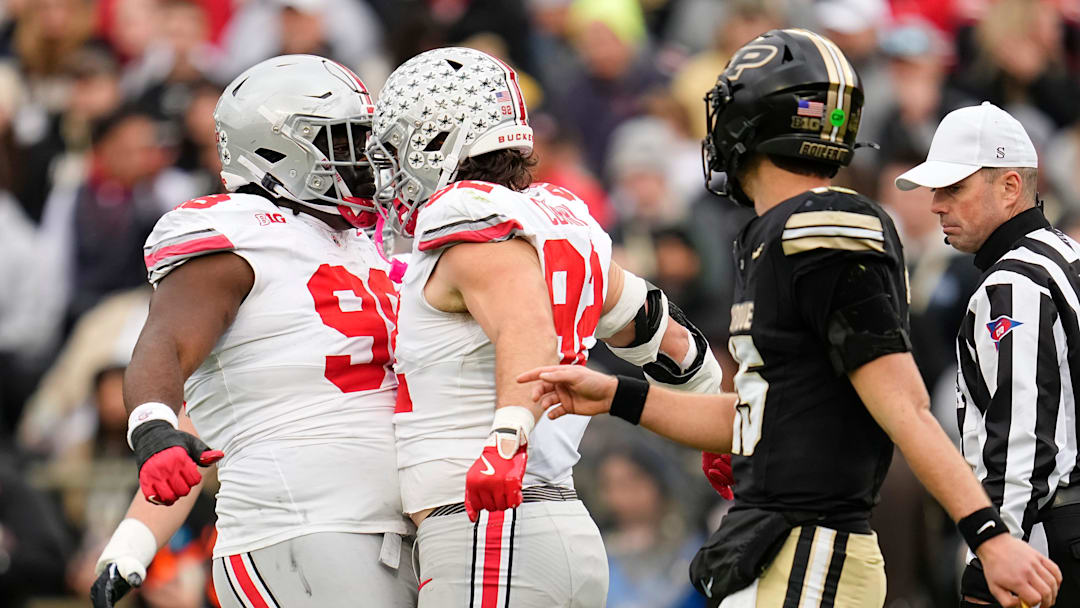 Ohio State Buckeyes defensive end Caden Curry (92) and defensive tackle Kayden McDonald (98) celebrate behidn Purdue Boilermakers quarterback Ryan Browne (15) during the NCAA football game at Ross-Ade Stadium in West Lafayette, Ind. on Nov. 8, 2025.