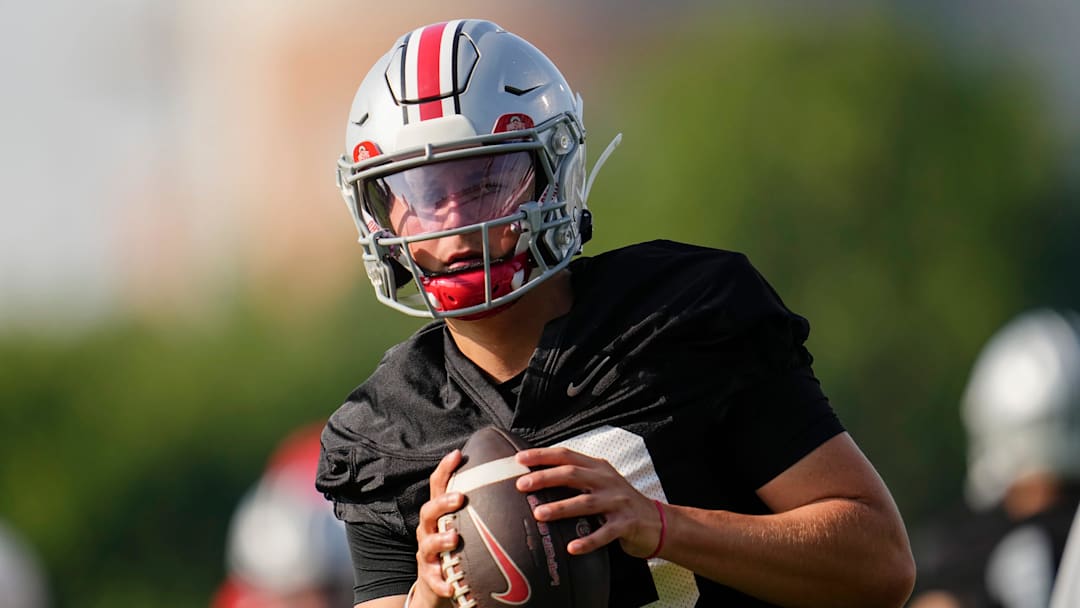 Ohio State Buckeyes quarterback Julian Sayin (10) takes a snap during football training camp at the Woody Hayes Athletic Center on Aug. 1, 2025.