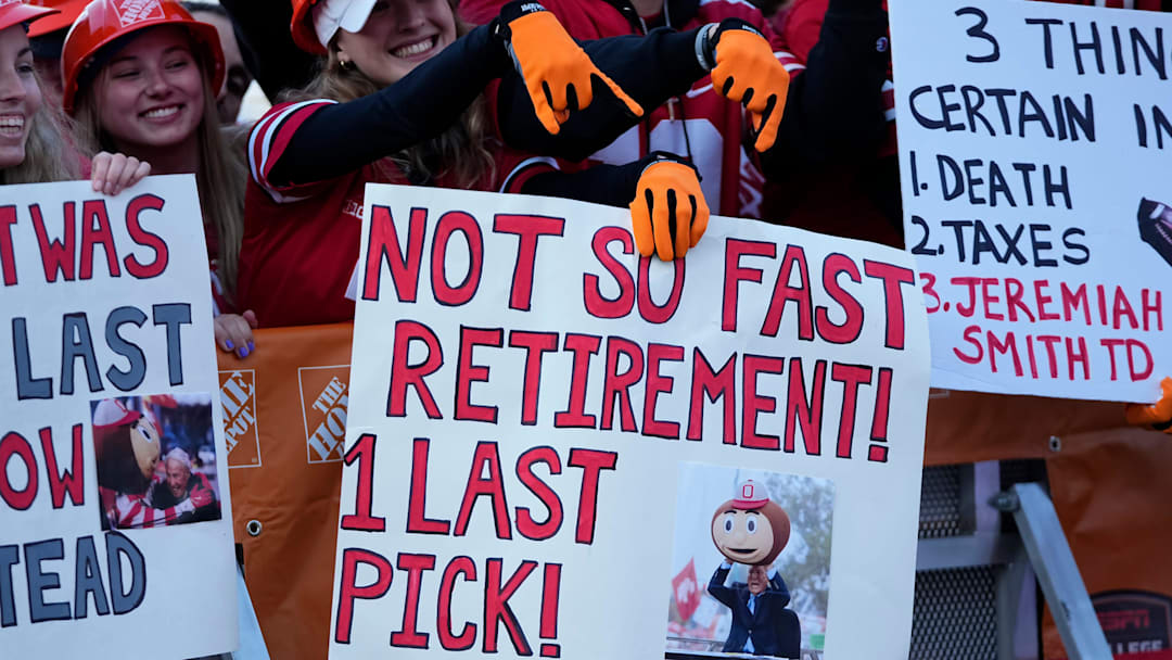 Fans hold signs in support of Lee Corso on the set of ESPN College GameDay prior to the NCAA football game between the Ohio State Buckeyes and the Texas Longhorns at Ohio Stadium on Aug. 30, 2025.