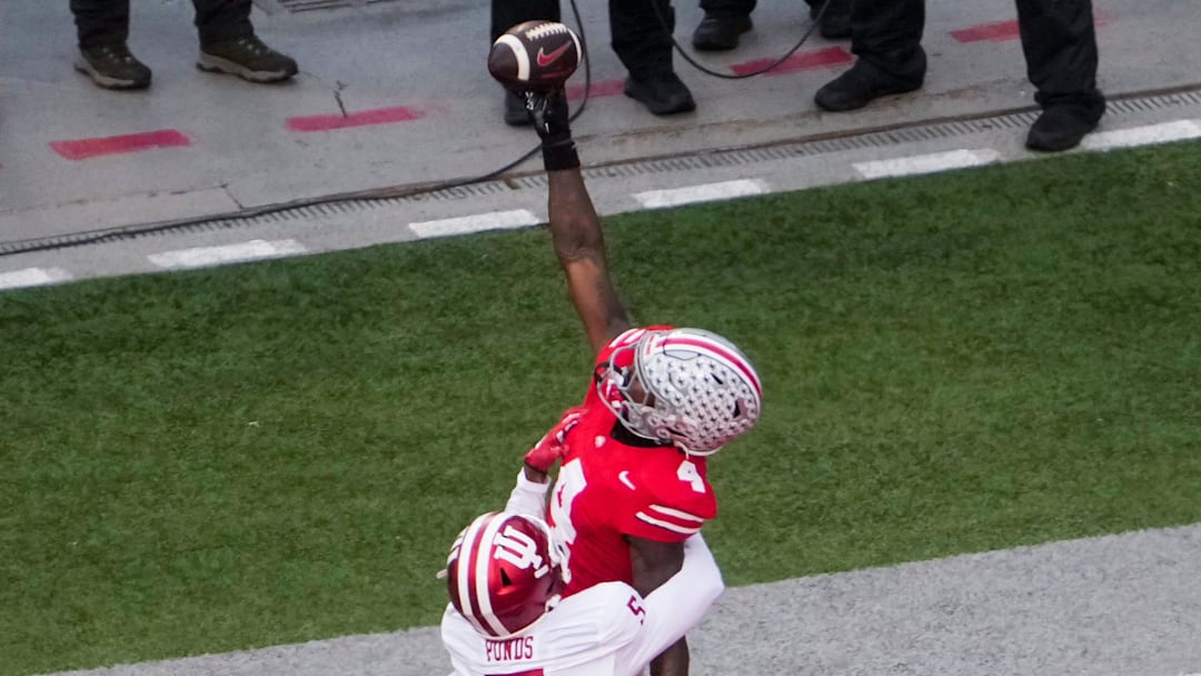Ohio State Buckeyes wide receiver Jeremiah Smith (4) attempts to catch a pass against Indiana Hoosiers defensive back D'Angelo Ponds (5) in the first half at Ohio Stadium on Saturday, Nov. 23, 2024 in Columbus, Ohio.