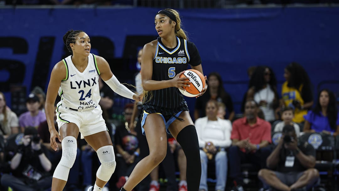 Jul 12, 2025; Chicago, Illinois, USA; Minnesota Lynx forward Napheesa Collier (24) defends against Chicago Sky forward Angel Reese (5) during the first half of a WNBA game at Wintrust Arena. 