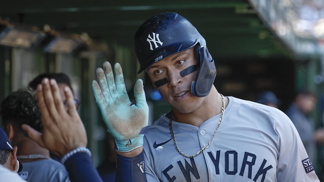 Sep 7, 2024; Chicago, Illinois, USA; New York Yankees outfielder Aaron Judge (99) celebrates with teammates in the dugout after scoring against the Chicago Cubs during the sixth inning at Wrigley Field. Mandatory Credit: Kamil Krzaczynski-Imagn Images