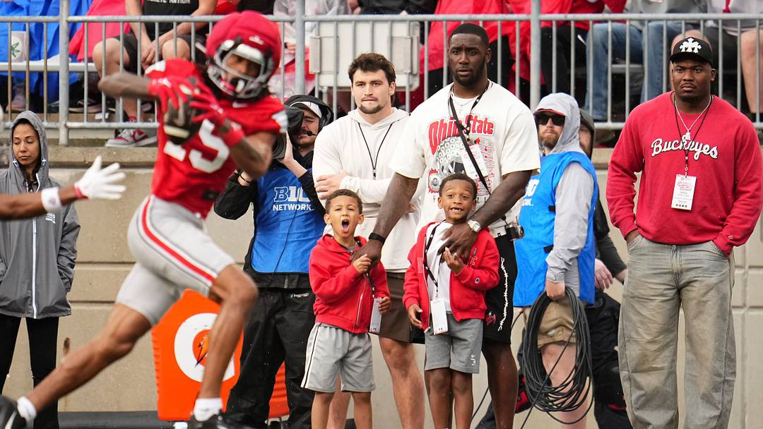 Former Ohio State Buckeyes defensive end Jalyn Holmes watches with his family as wide receiver Chris Henry Jr. (15) catches a pass during the Ohio State football spring game at Ohio Stadium in Columbus on April 18, 2026.