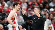 Mar 26, 2024; Columbus, OH, USA; Ohio State Buckeyes head coach Jake Diebler talks to forward Jamison Battle (10) during the second half of the NIT quarterfinals against the Georgia Bulldogs at Value City Arena. Ohio State lost 79-77.